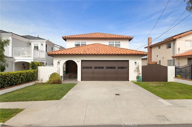 mediterranean / spanish-style house featuring an attached garage, fence, driveway, a tiled roof, and stucco siding