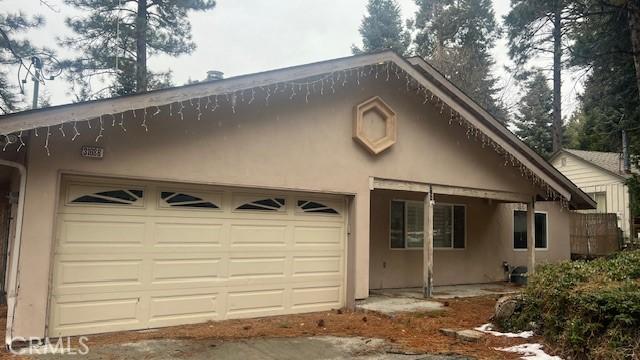 exterior space with a garage and stucco siding