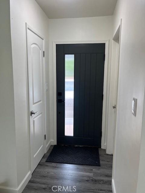 entryway with baseboards and wood finished floors