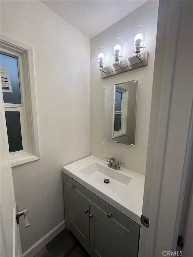 bathroom featuring baseboards and vanity