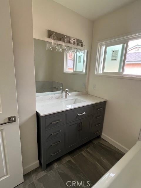 bathroom featuring baseboards and vanity