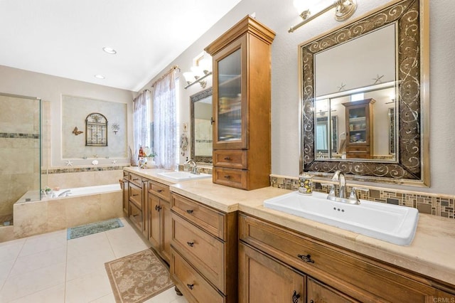 bathroom featuring a bath, double vanity, a sink, and tile patterned floors