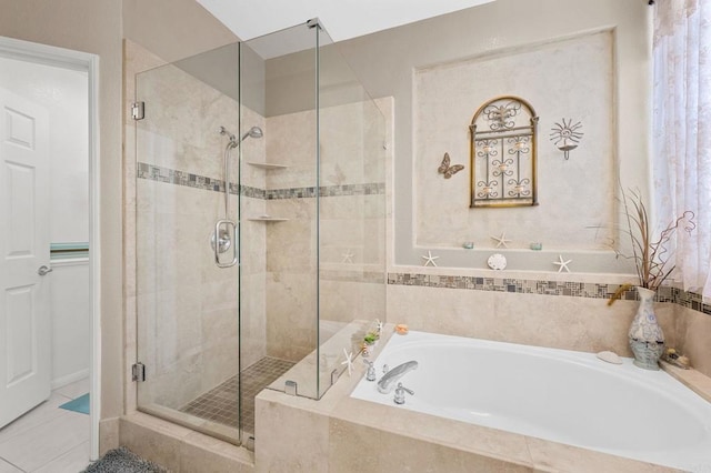 bathroom featuring tile patterned flooring, a shower stall, and a bath