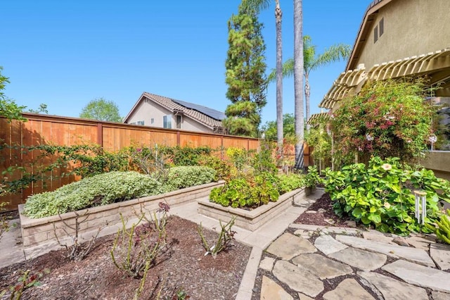 view of yard with a fenced backyard, a vegetable garden, and a pergola