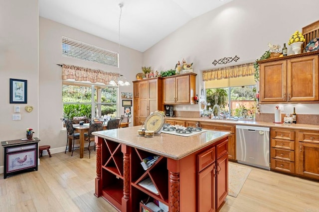 kitchen featuring white gas cooktop, a healthy amount of sunlight, light wood-style floors, dishwasher, and open shelves