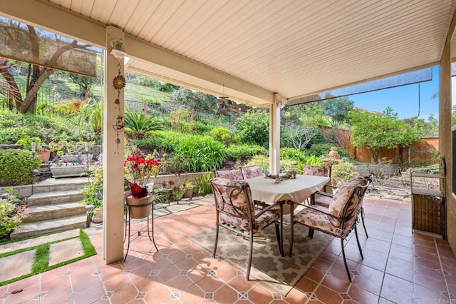 view of patio with fence and outdoor dining area