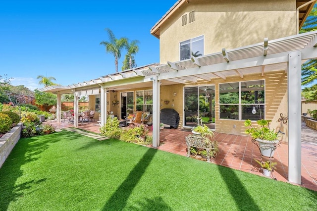 back of house with a patio, a lawn, a pergola, and stucco siding