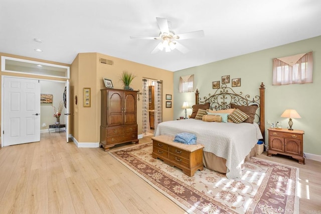 bedroom with visible vents, light wood-style flooring, a ceiling fan, connected bathroom, and baseboards