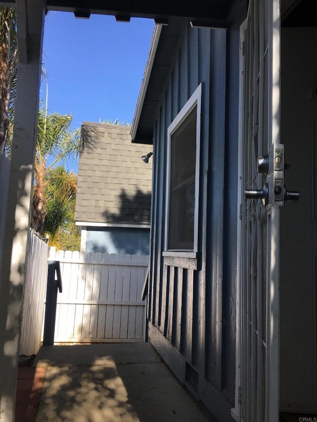 view of side of property featuring fence