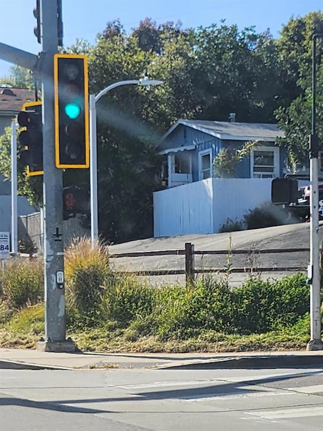 exterior space featuring curbs, traffic lights, and sidewalks