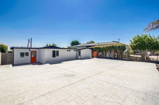 single story home featuring fence and stucco siding