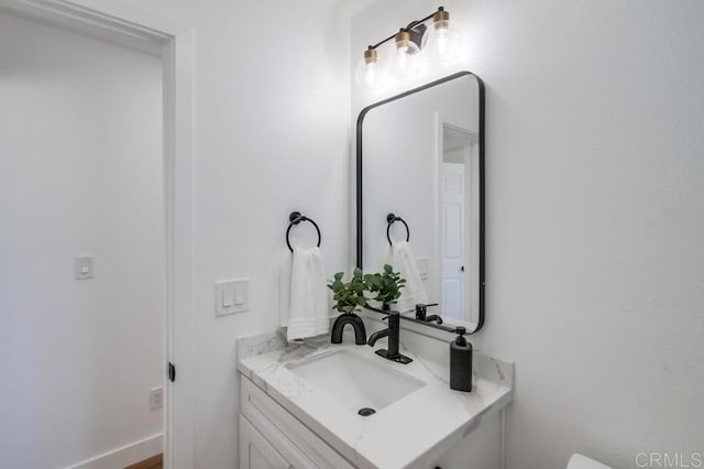 bathroom with vanity and baseboards