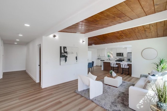 living room with light wood finished floors, wood ceiling, baseboards, and recessed lighting