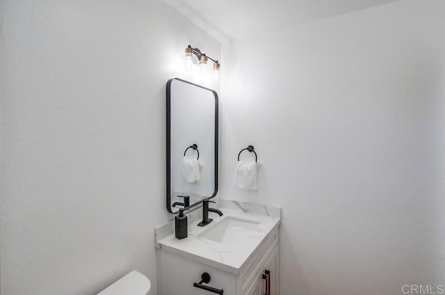 half bath with vanity and toilet