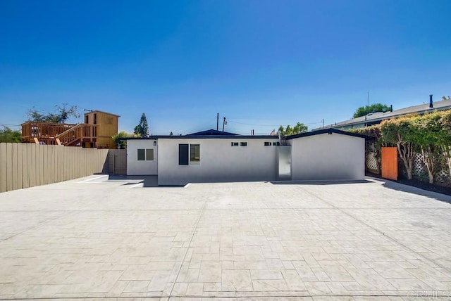 view of front of home with fence and stucco siding