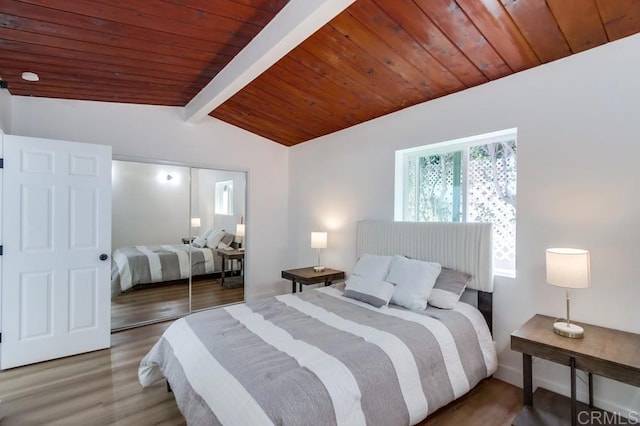 bedroom featuring vaulted ceiling with beams, wooden ceiling, and wood finished floors