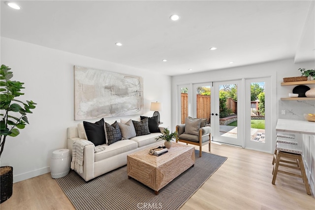 living area with light wood-type flooring, baseboards, french doors, and recessed lighting