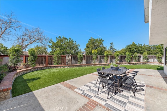 view of patio featuring a fenced backyard and outdoor dining area