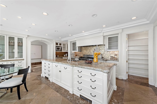 50 Pelican Crest Dr, Newport Coast, CA 92657 - kitchen with arched walkways, ornamental molding, stainless steel microwave, a sink, and recessed lighting