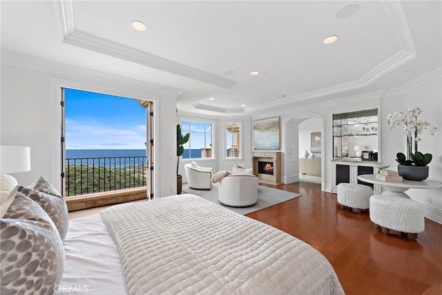 50 Pelican Crest Dr, Newport Coast, CA 92657 - bedroom featuring crown molding, a raised ceiling, wood finished floors, access to outside, and a warm lit fireplace
