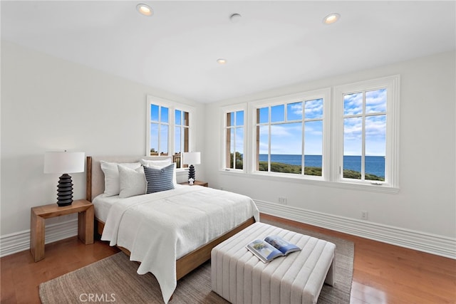 50 Pelican Crest Dr, Newport Coast, CA 92657 - bedroom with recessed lighting, a water view, baseboards, and wood finished floors