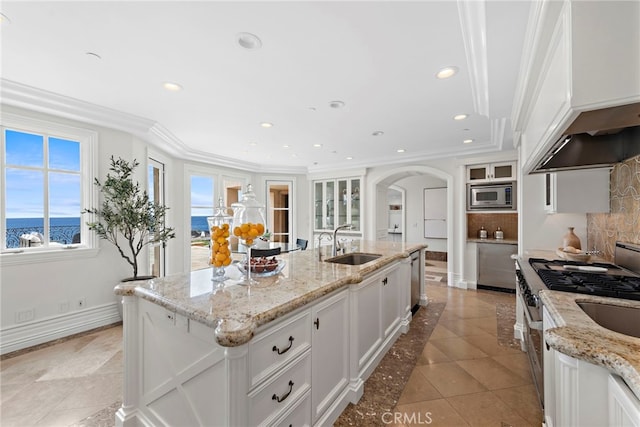 50 Pelican Crest Dr, Newport Coast, CA 92657 - kitchen featuring arched walkways, backsplash, appliances with stainless steel finishes, white cabinets, and a sink