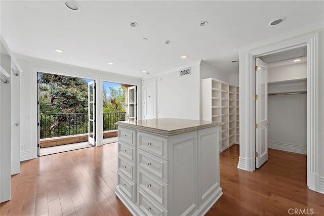 50 Pelican Crest Dr, Newport Coast, CA 92657 - kitchen with crown molding, visible vents, light stone counters, and wood finished floors