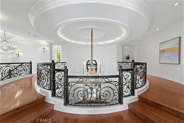 50 Pelican Crest Dr, Newport Coast, CA 92657 - stairs featuring a tray ceiling, crown molding, wood finished floors, a chandelier, and baseboards