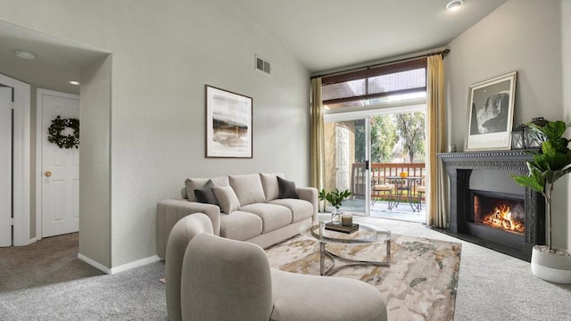 carpeted living area featuring a fireplace with flush hearth, visible vents, vaulted ceiling, and baseboards