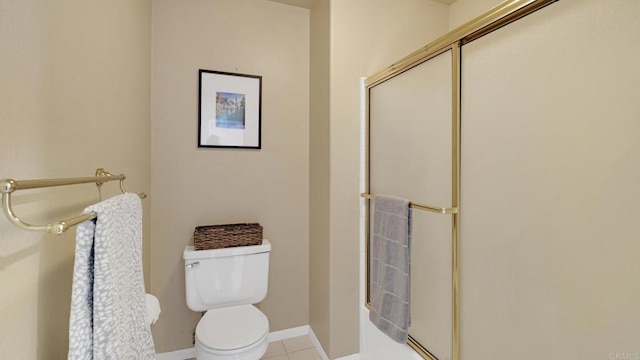 bathroom with baseboards, toilet, and tile patterned floors