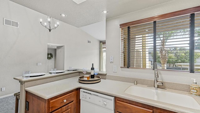 kitchen with white dishwasher, a sink, visible vents, light countertops, and brown cabinetry