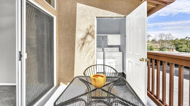 balcony with washing machine and dryer