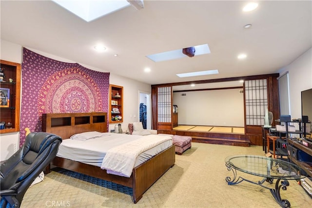 carpeted bedroom with a skylight and recessed lighting