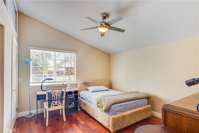 bedroom featuring a ceiling fan, baseboards, vaulted ceiling, and wood finished floors