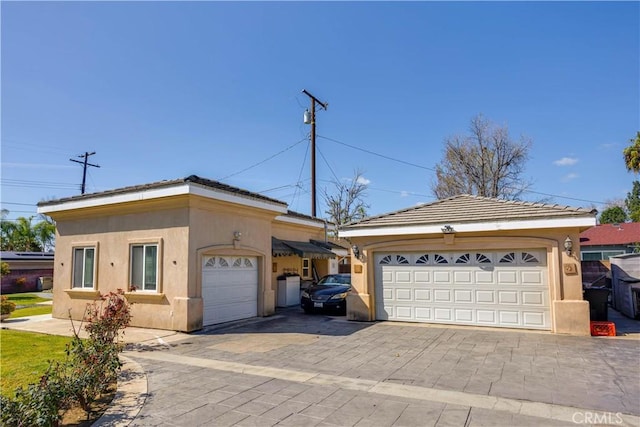 view of front of property featuring a garage and stucco siding