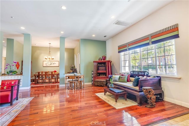 interior space with recessed lighting, a notable chandelier, baseboards, and wood finished floors