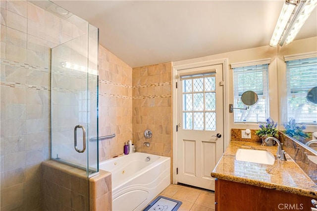 full bath with tile patterned flooring, vanity, vaulted ceiling, a shower stall, and a whirlpool tub