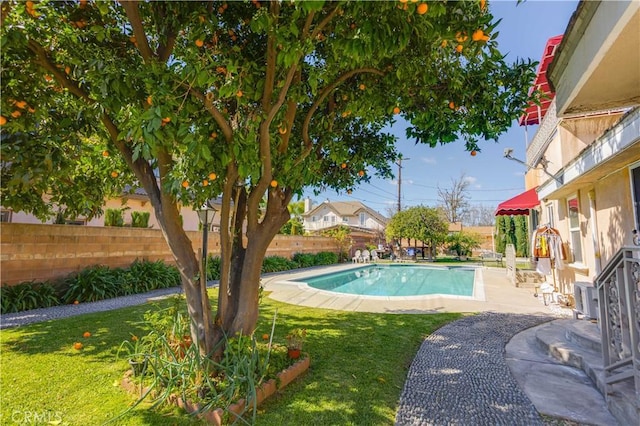 view of swimming pool with a fenced backyard, a fenced in pool, a lawn, and a patio