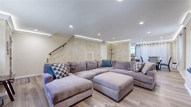 living room featuring ornamental molding, recessed lighting, light wood-style flooring, and baseboards