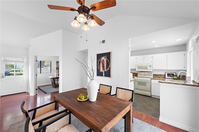 dining space with baseboards, visible vents, dark wood-style floors, vaulted ceiling, and recessed lighting