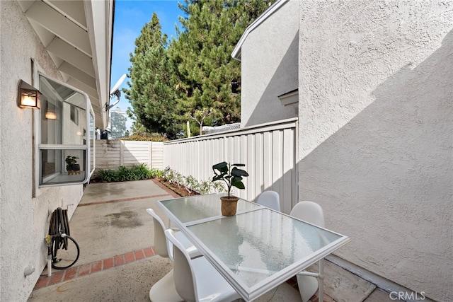 view of patio with fence and outdoor dining area