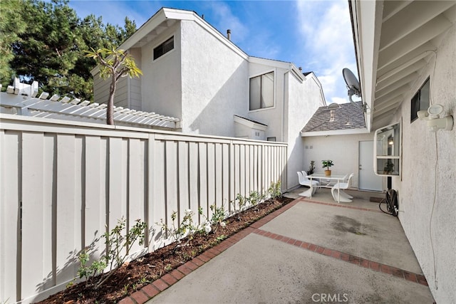 view of patio featuring fence