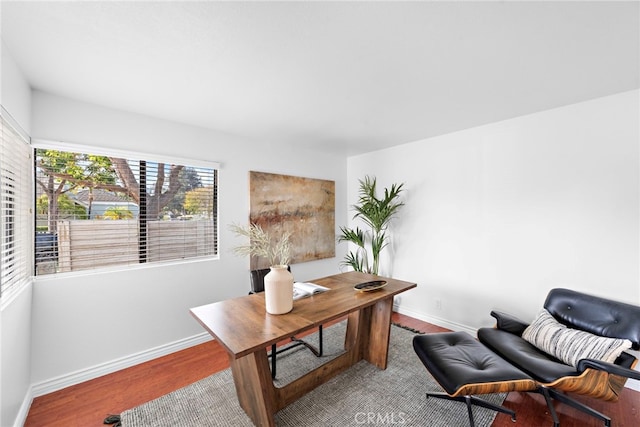 home office featuring wood finished floors and baseboards