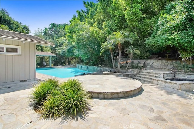 outdoor pool with a patio area