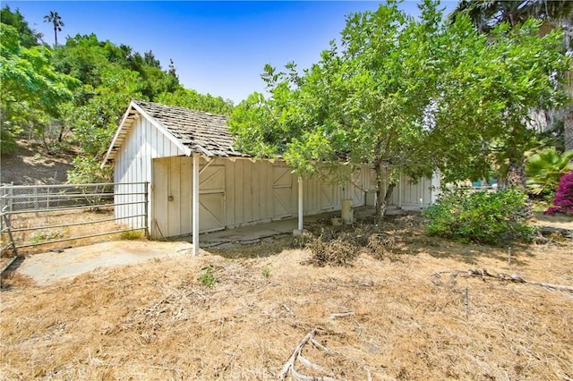 view of outbuilding with an outbuilding and fence