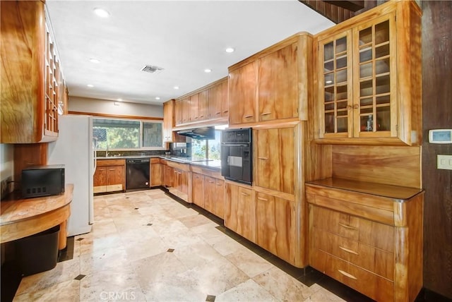 kitchen featuring recessed lighting, visible vents, brown cabinets, black appliances, and glass insert cabinets