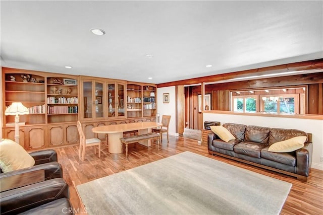 living area with light wood-style floors and recessed lighting