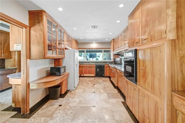 kitchen with visible vents, brown cabinetry, glass insert cabinets, black appliances, and recessed lighting