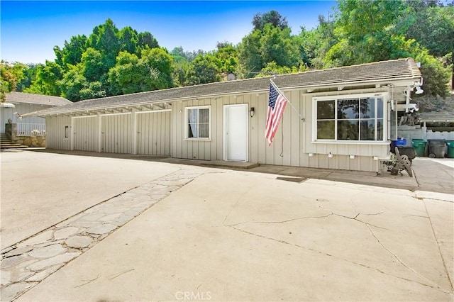 view of front facade with a patio area and board and batten siding