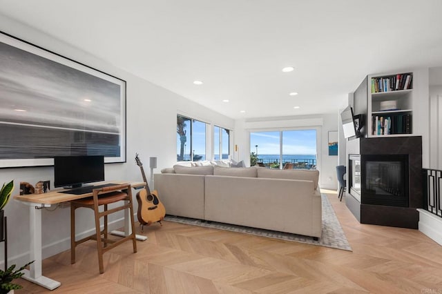 living room with a multi sided fireplace and recessed lighting